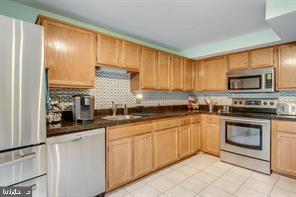 17 Devon Court Sterling, VA 20165 - Photo 12 of 30 a kitchen with granite countertop a sink stainless steel appliances and cabinets