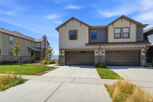 6039 North Westridge Road Heber City, UT 84032 - Photo 59 of 71 Modern exterior with stone accents, attached two-car garage, and concrete driveway