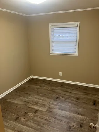 a view of a room with wooden floor and fan