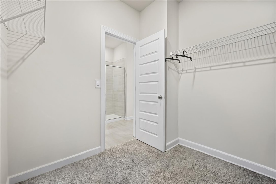 106 Purcell Way Easley, SC 29642 - Photo 22 of 39 This spacious closet features ample storage, with convenient access to a modern shower.