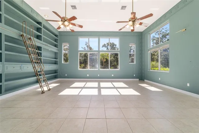 a kitchen with a sink and large windows