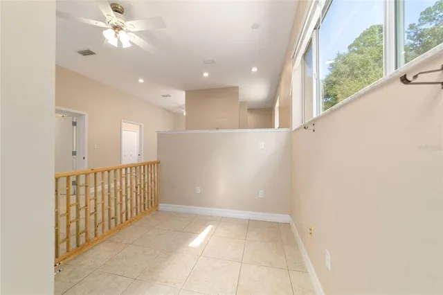 a view of a livingroom with a hardwood floor and a ceiling fan