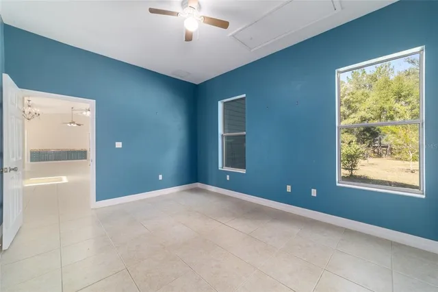 a balcony with wooden floor and yard in the back
