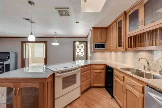 a kitchen with a stove sink and cabinets