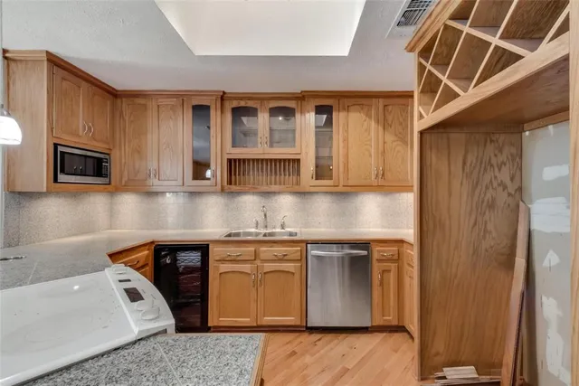 a kitchen with stainless steel appliances granite countertop a sink and cabinets