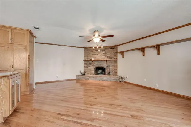 a view of a livingroom with a ceiling fan hardwood floor and a ceiling fan