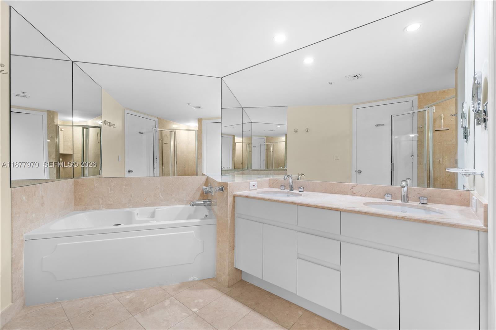 848 Brickell Key Drive, Unit 2502 Miami, FL 33131 - Photo 24 of 40 a bathroom with a bathtub a double vanity sink and mirror