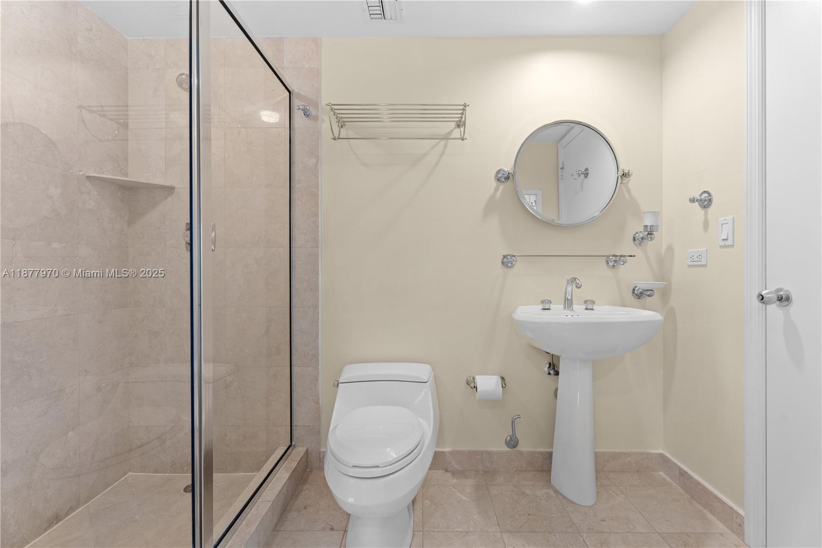 848 Brickell Key Drive, Unit 2502 Miami, FL 33131 - Photo 28 of 40 a bathroom with a sink toilet and a mirror