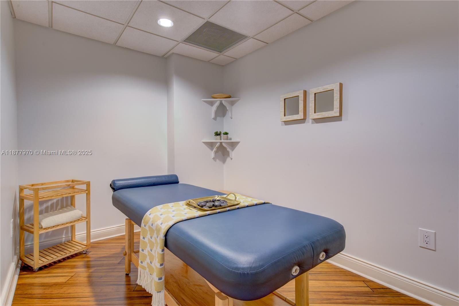 848 Brickell Key Drive, Unit 2502 Miami, FL 33131 - Photo 38 of 40 a bedroom with a bed and wooden floor