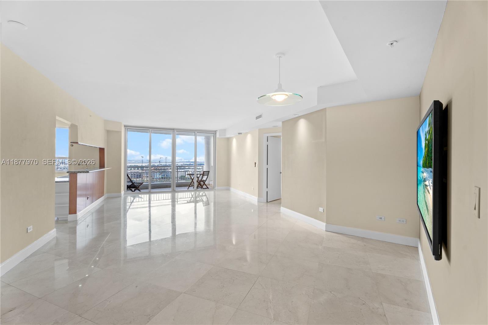 848 Brickell Key Drive, Unit 2502 Miami, FL 33131 - Photo 8 of 40 a view of a livingroom with furniture and a kitchen