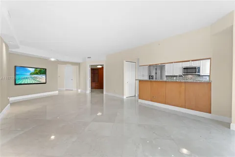 a view of a kitchen with a sink and a cabinet