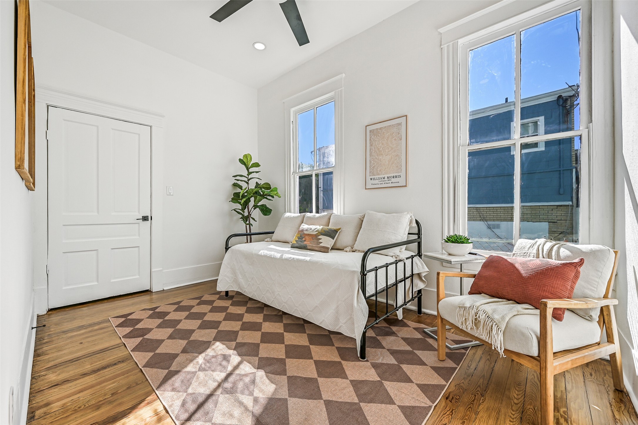 2010 Rosenberg Street Galveston, TX 77550 - Photo 23 of 50 This first-floor bedroom offers comfort and versatility! Sunlight streams through wide windows, highlighting the fresh, remodeled finishes. Perfect as a guest retreat, in-law suite, or private home office, it connects easily to the kitchen and main living areas.