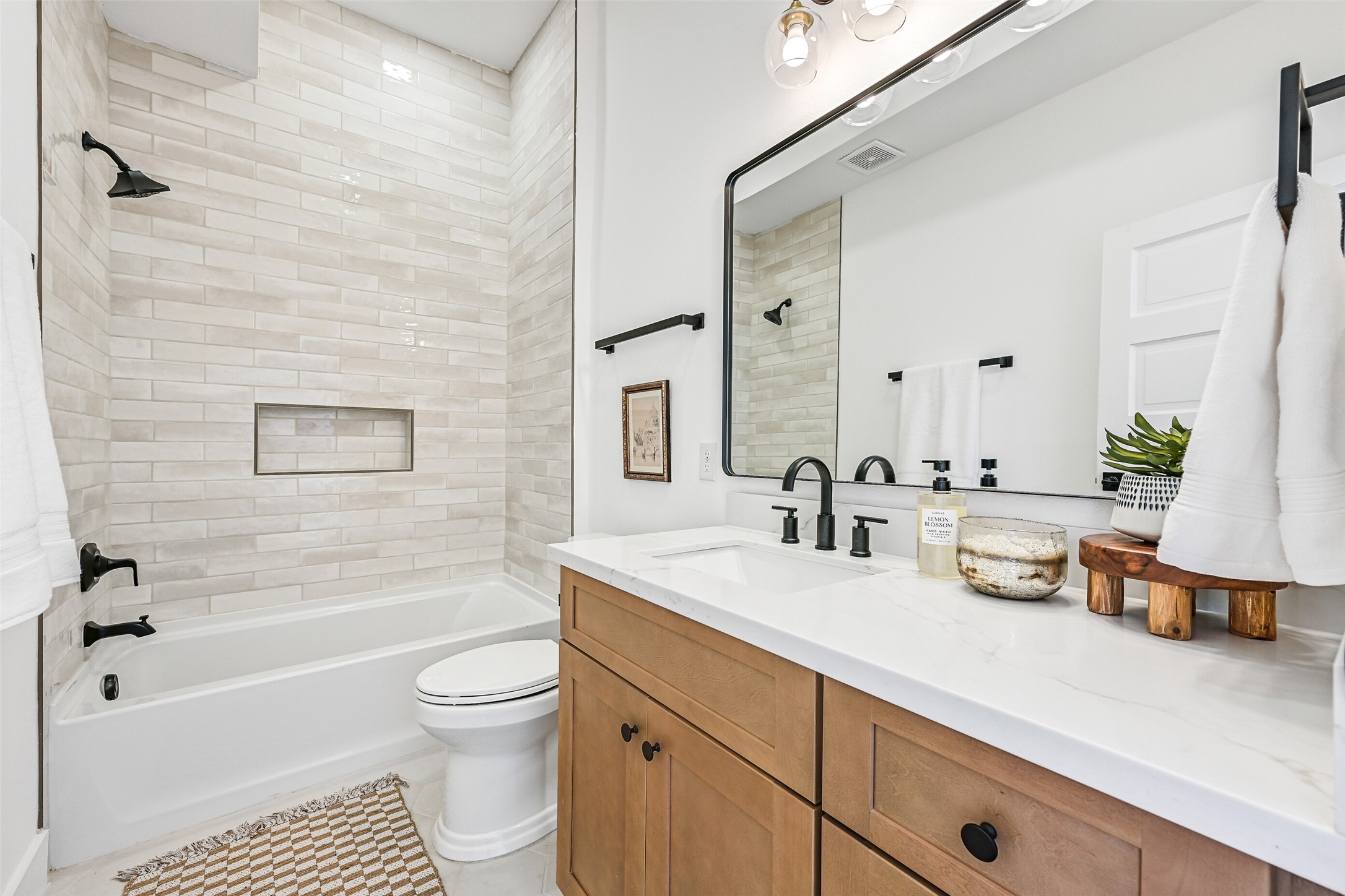 2010 Rosenberg Street Galveston, TX 77550 - Photo 25 of 50 From this perspective, you can truly appreciate the spacious layout and refined finishes of the ensuite bath. Sunlight reflects off the clean tile design and bright surfaces, creating a serene space that balances coastal elegance with everyday ease — a bathroom that makes mornings effortless and evenings perfectly relaxing.