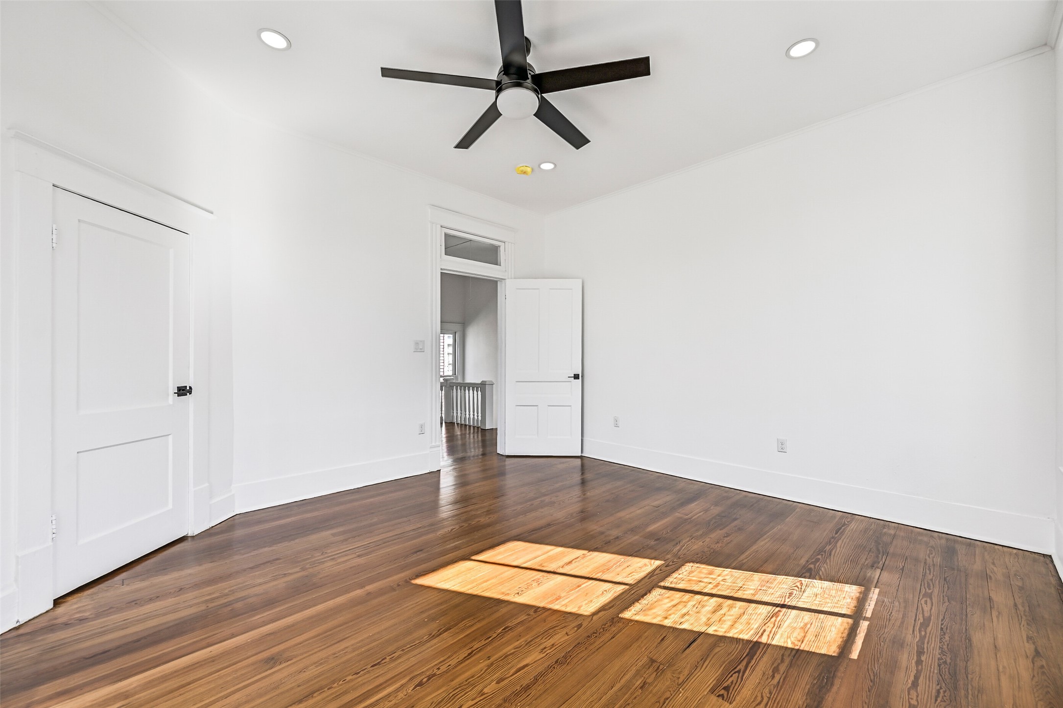 2010 Rosenberg Street Galveston, TX 77550 - Photo 27 of 50 Another look at this cozy haven shows off its warmth and versatility! Sunlight dances across the hardwoods, highlighting the serene vibe. Perfect for guests, family, or a quiet reading nook, this room embodies everyday comfort in true Galveston style.