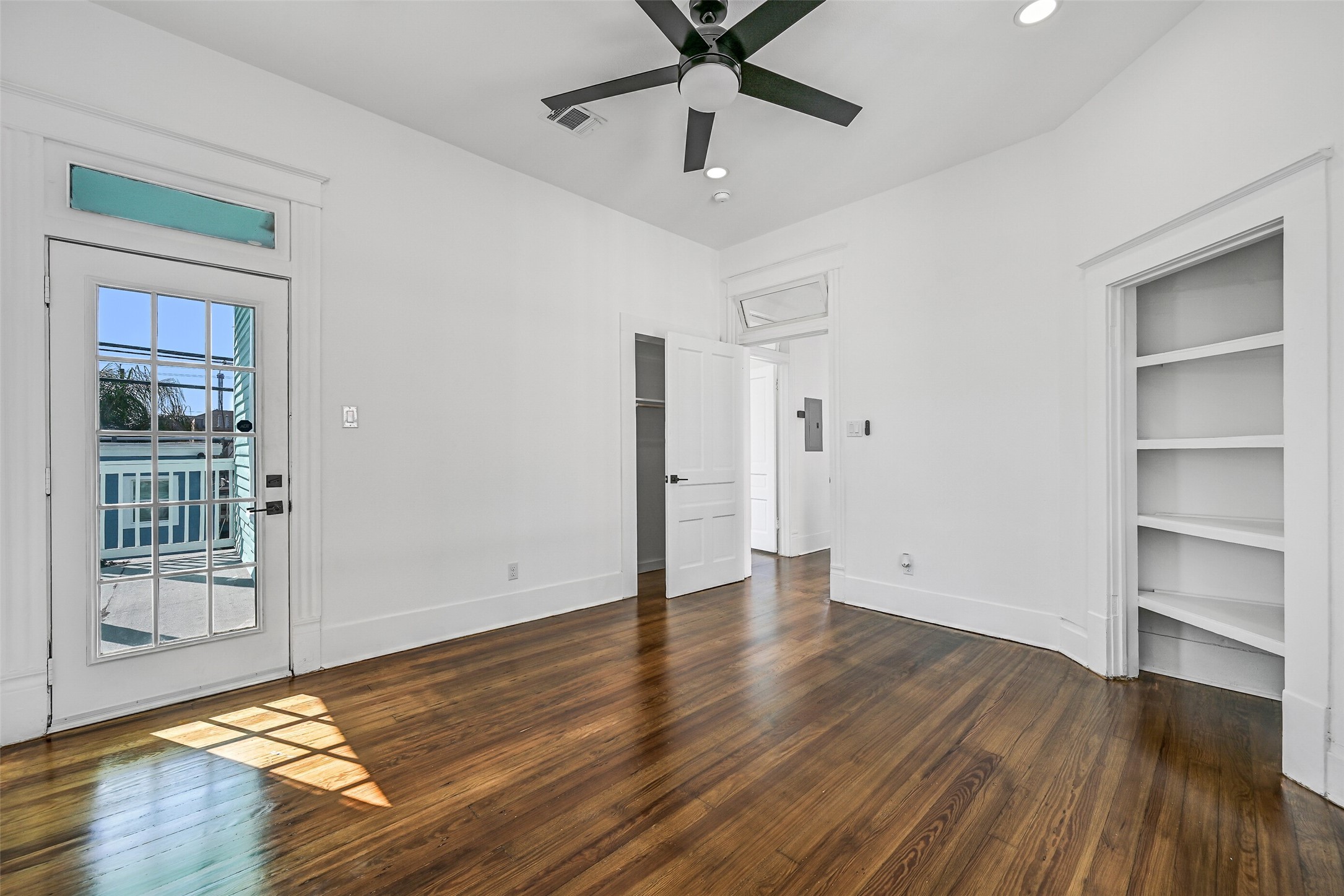 2010 Rosenberg Street Galveston, TX 77550 - Photo 33 of 50 Your private sanctuary awaits! The spacious primary bedroom features a ceiling fan, built-in storage nook, and access to the upper terrace, where morning breezes and evening starlight set the perfect mood. Comfort and elegance combine in this owner’s retreat that feels both luxurious and deeply relaxing.