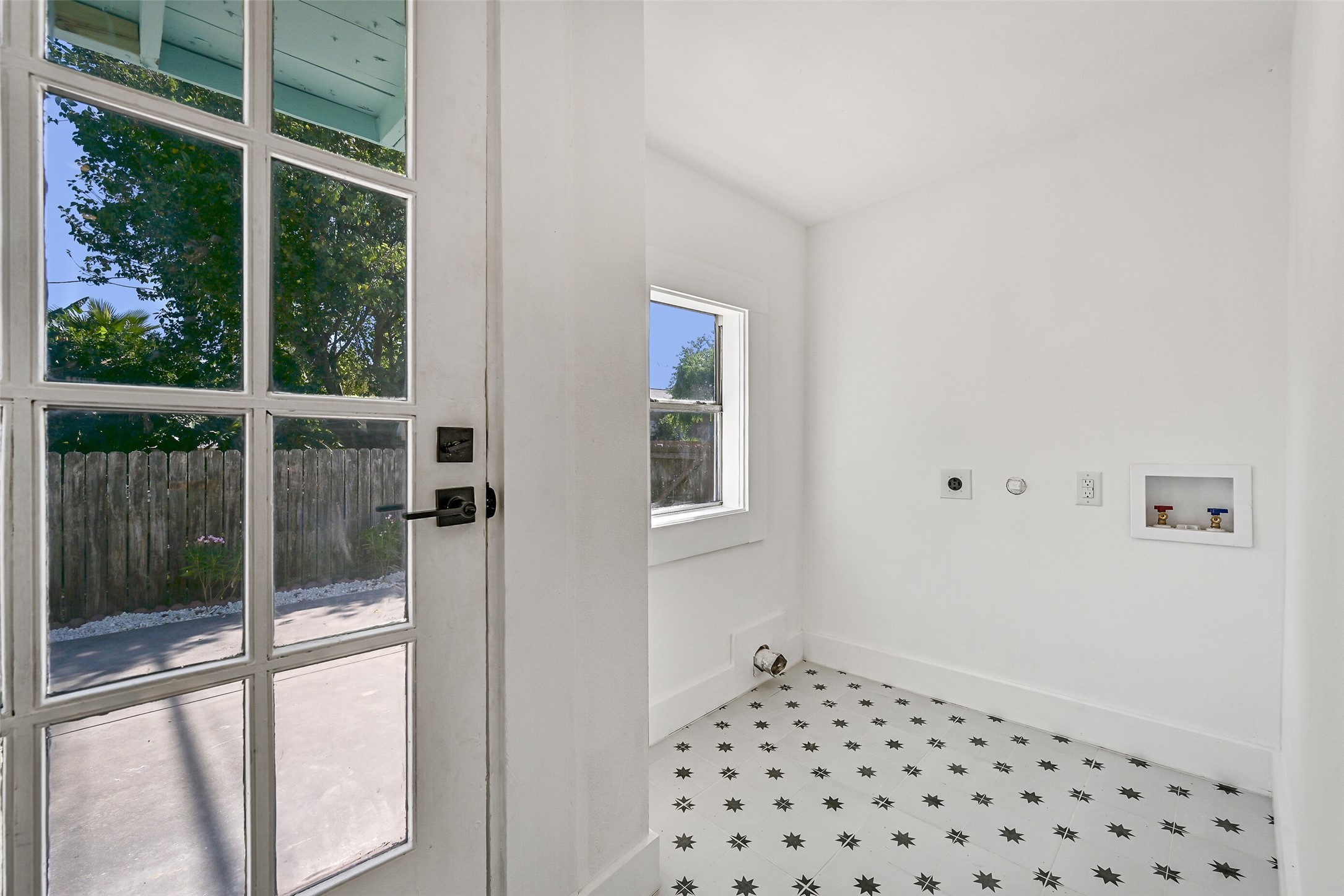 2010 Rosenberg Street Galveston, TX 77550 - Photo 36 of 50 Everyday convenience meets smart design in this bright laundry space! Tucked just off the hallway with easy access to the backyard, it’s the perfect blend of practicality and comfort. Imagine breezy laundry days with the door open to sunshine and fresh air, everything at your fingertips. A must-have for island living — efficient, private, and beautifully placed at the heart of the home.