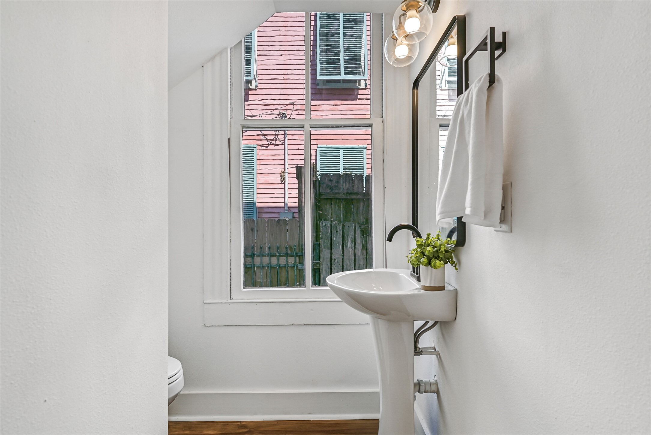 2010 Rosenberg Street Galveston, TX 77550 - Photo 37 of 50 Chic and convenient! This half bath is perfectly positioned off the foyer for guests and daily ease. Stylish fixtures, bright lighting, and crisp finishes make a small space feel elegant and impactful — ideal for entertaining or a busy household on the go.