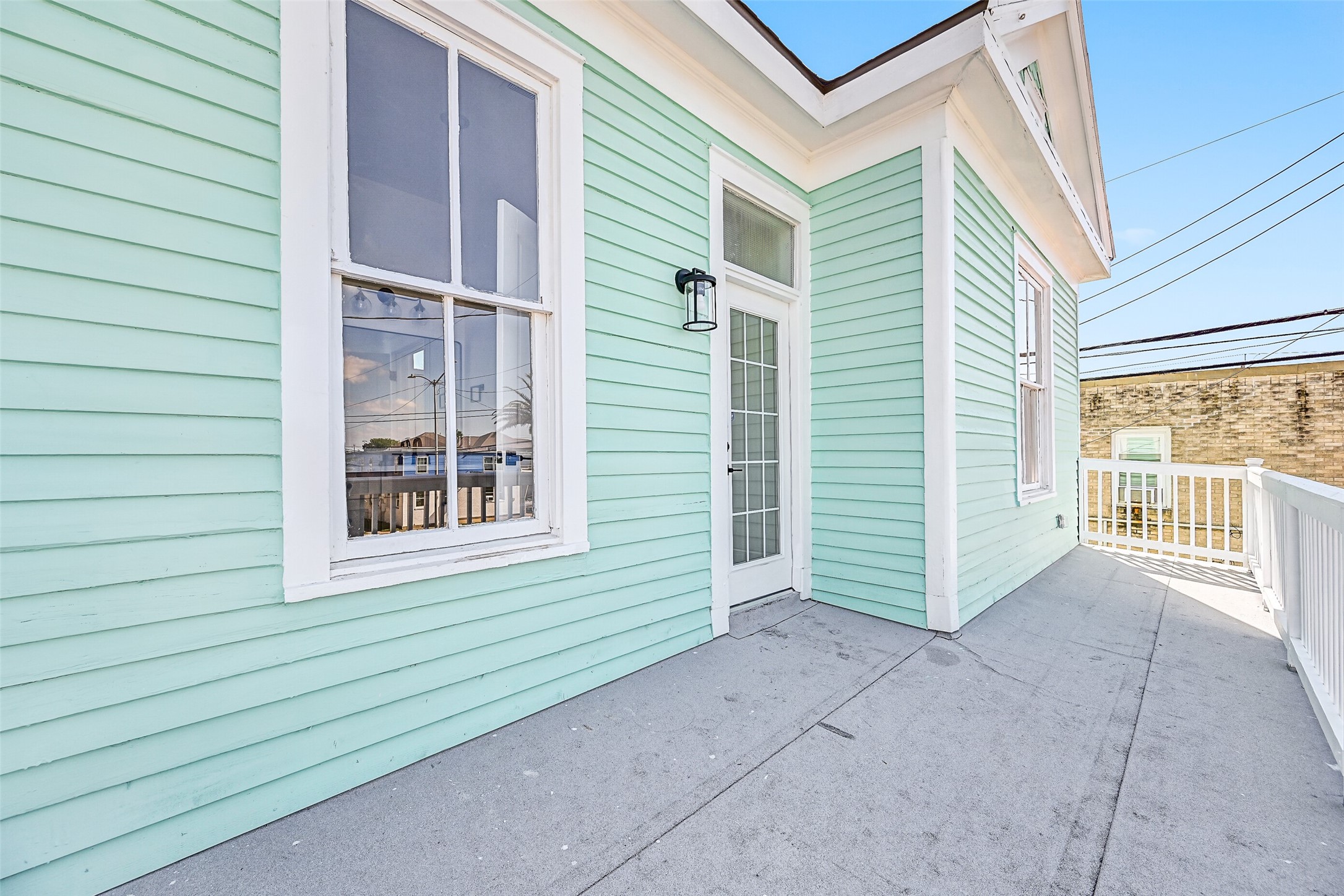 2010 Rosenberg Street Galveston, TX 77550 - Photo 38 of 50 Step outside and feel the breeze! This inviting balcony offers the perfect spot for morning coffee or parade watching along 25th Street. Surrounded by sunshine, fresh air, and coastal energy, it’s a front-row seat to island life — relaxed, joyful, and full of charm.