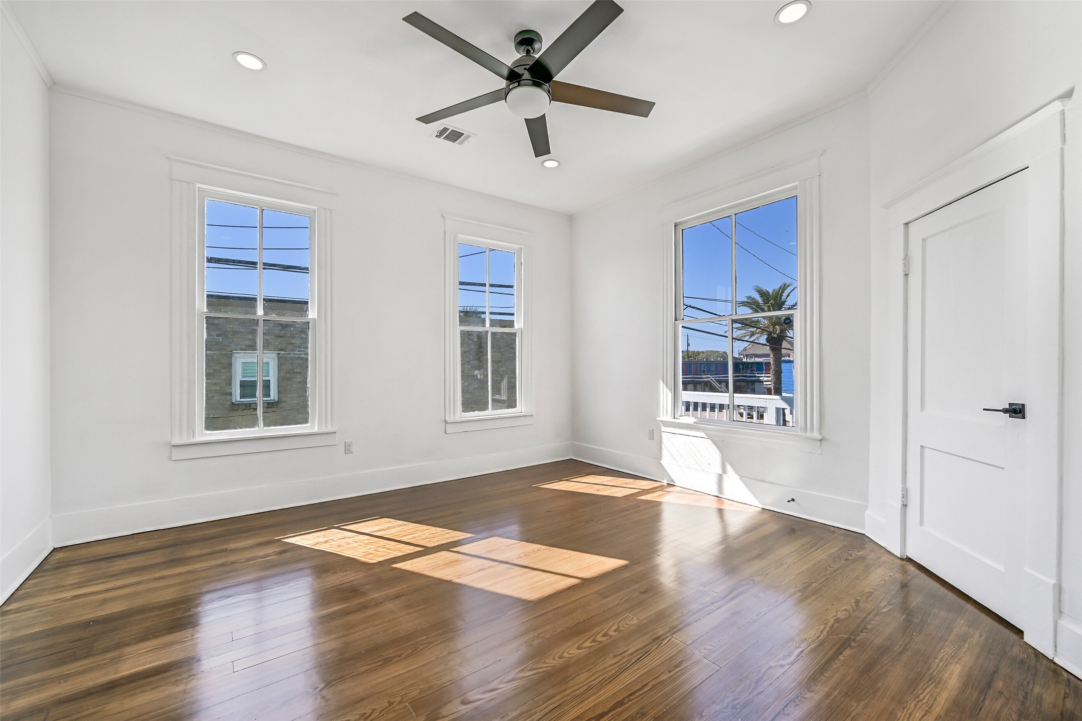 2010 Rosenberg Street Galveston, TX 77550 - Photo 4 of 50 Bright, airy, and full of charm! Bedroom #2 offers a welcoming retreat with soft natural light, gleaming hardwood floors, and a cooling ceiling fan for those breezy island nights. Spacious enough for rest, work, or creativity — it’s the kind of room that instantly feels like home, freshly remodeled and ready for its next chapter.