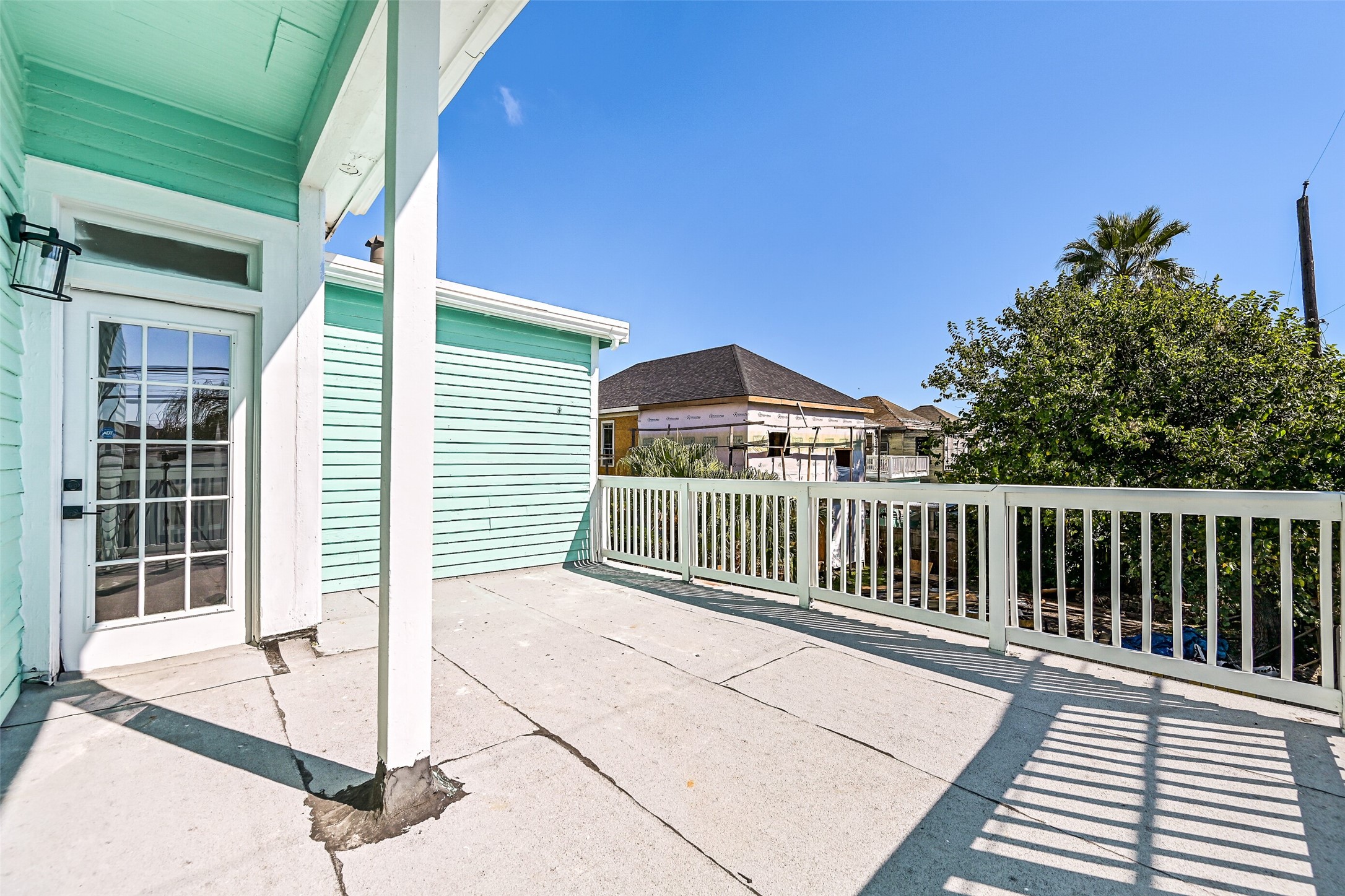 2010 Rosenberg Street Galveston, TX 77550 - Photo 40 of 50 From this angle, the terrace reveals its true magic — a serene overlook of the backyard and neighborhood, kissed by Gulf air and golden light. Whether you’re lounging solo or sharing a peaceful moment, this space delivers that “vacation every day” feeling right at home.