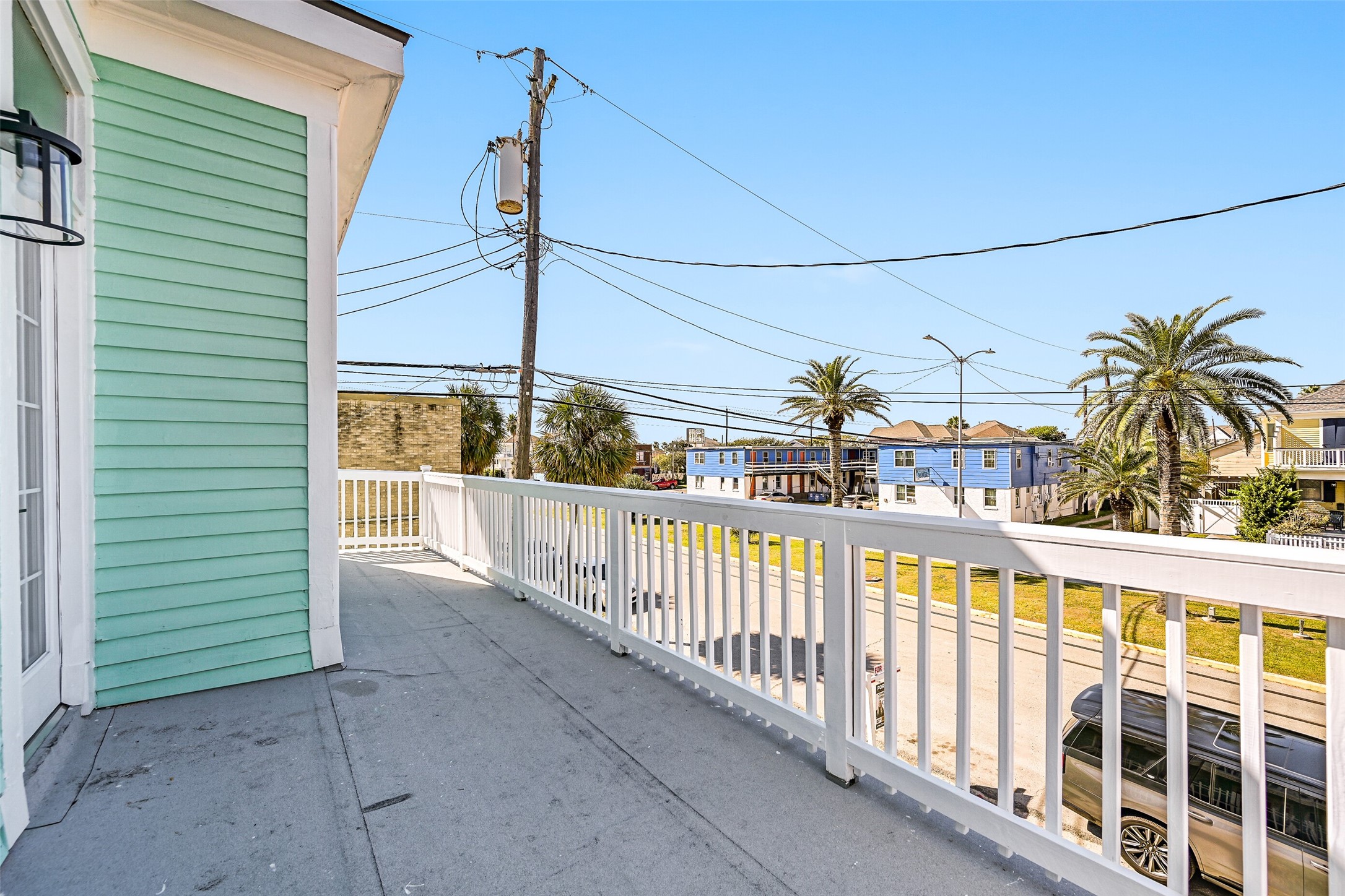 2010 Rosenberg Street Galveston, TX 77550 - Photo 41 of 50 From this view, the balcony becomes your personal retreat — perfect for sunset moments or quiet nights under the stars. With plenty of space to lounge or gather, it’s where every day feels like a vacation, and every evening ends with a little coastal magic.