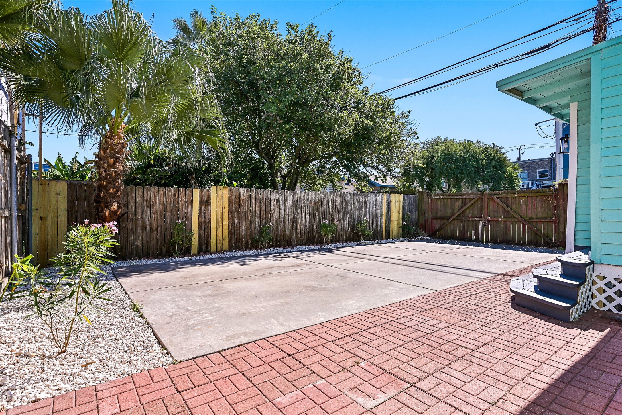 2010 Rosenberg Street Galveston, TX 77550 - Photo 43 of 50 Step outside to your private fenced backyard — the ultimate space for gatherings, grilling, or relaxing in the coastal breeze! Beautifully hardscaped with brick pavers, this low-maintenance retreat offers plenty of room for outdoor dining, lounging, and entertaining. There’s even space for pets to roam freely and play! Imagine weekend barbecues, evening hangouts under the stars, and easy access straight from the house. This inviting backyard is your OUTDOOR OASIS — perfect for island living at its best!