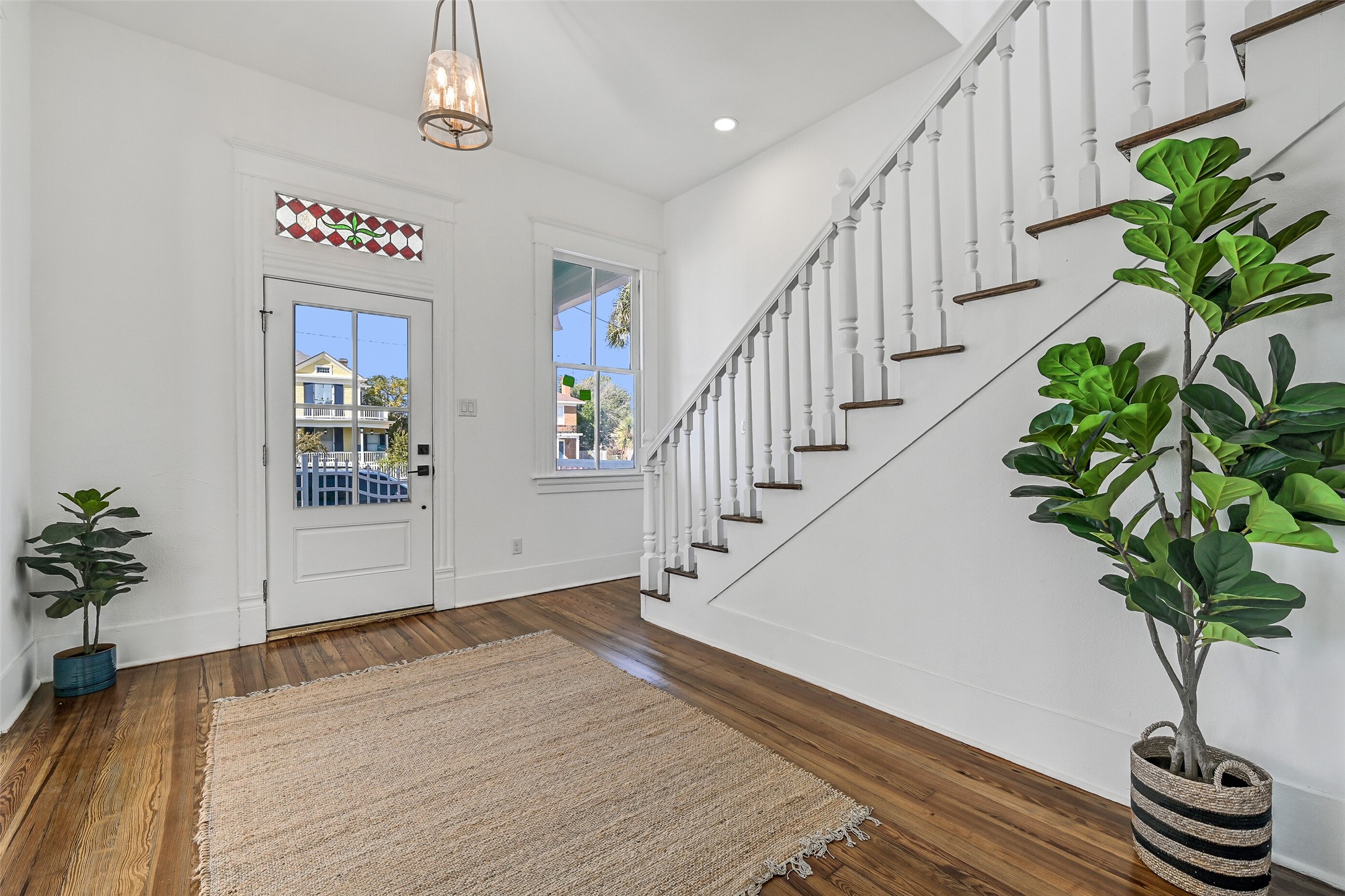 2010 Rosenberg Street Galveston, TX 77550 - Photo 7 of 50 The moment you step through the new front door, this entry captures your heart! Soft natural light dances across resurfaced hardwood floors, highlighting open sightlines and inviting you deeper in. To the right, the cozy living room awaits; straight ahead, the expanded kitchen with quartz island gleams with promise. Every detail — from updated lighting to restored woodwork — radiates warmth and welcome. It’s more than a foyer… it’s the first heartbeat of home!