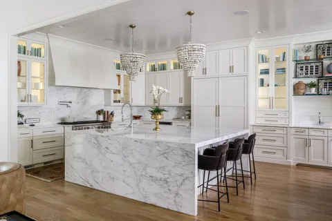 a view of kitchen center island wooden floor and living room