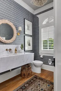 a living room with furniture chandelier and a fireplace
