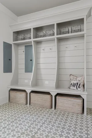 an aerial view of a house with outdoor space and trees all around