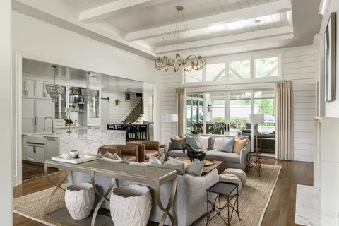 a living room with furniture and kitchen view
