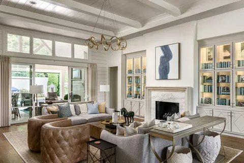 a large kitchen with granite countertop a stove a sink a refrigerator and white cabinets with wooden floor