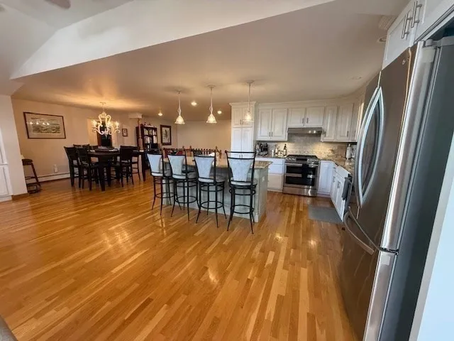 a view of a dining room with furniture and wooden floor