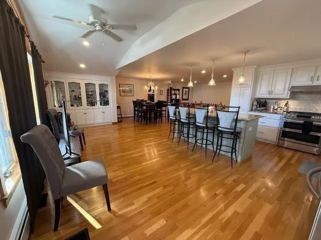 a view of a dining room with furniture and chandelier