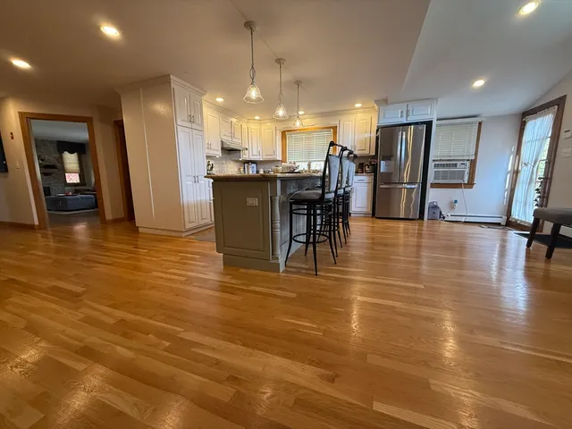 a view of a lobby with furniture and a kitchen