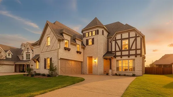 front view of a brick house with a yard