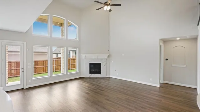 a view of a hallway with wooden floor and a fireplace