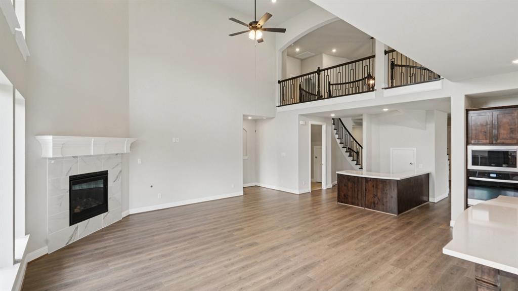 2805 Augustus Way Mansfield, TX 76063 - Photo 9 of 40 a view of a hallway with wooden floor and a fireplace