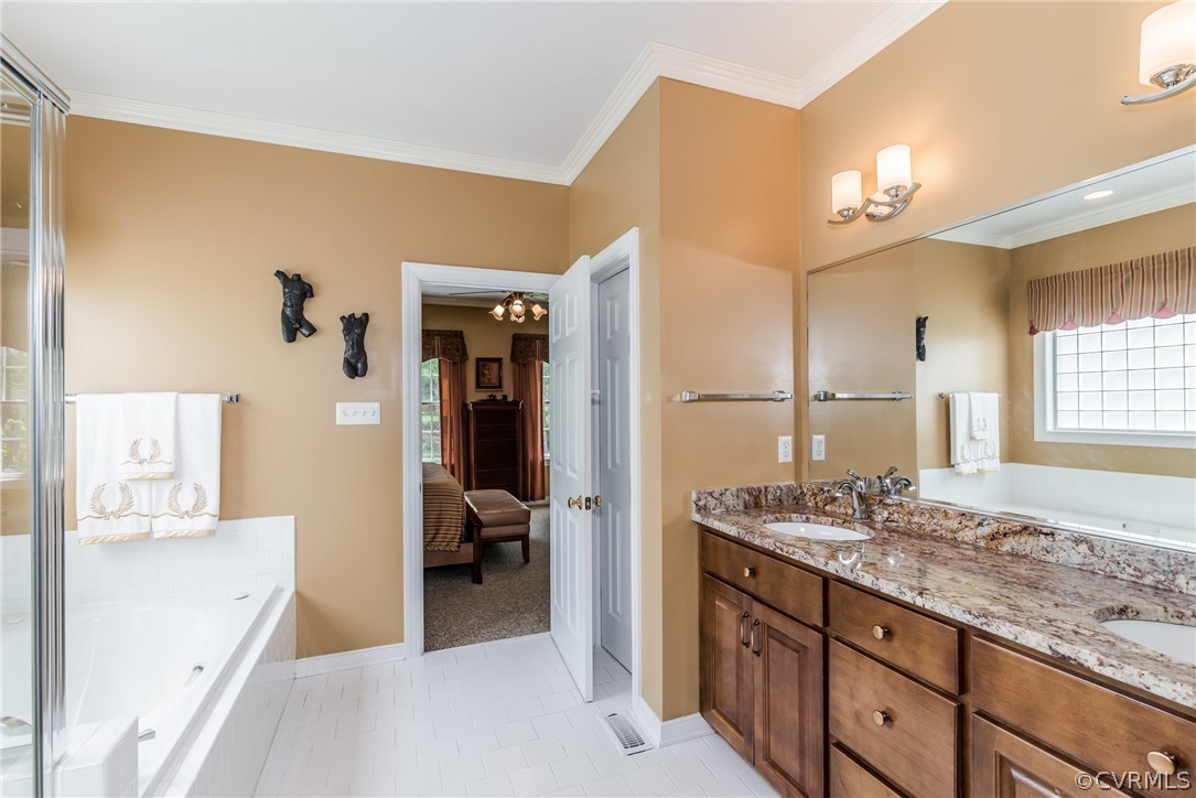845 Club Ridge Court Chester, VA 23836 - Photo 11 of 37 a spacious bathroom with a granite countertop sink a mirror and a shower