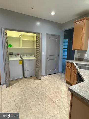 a view of an empty room with wooden floor and windows
