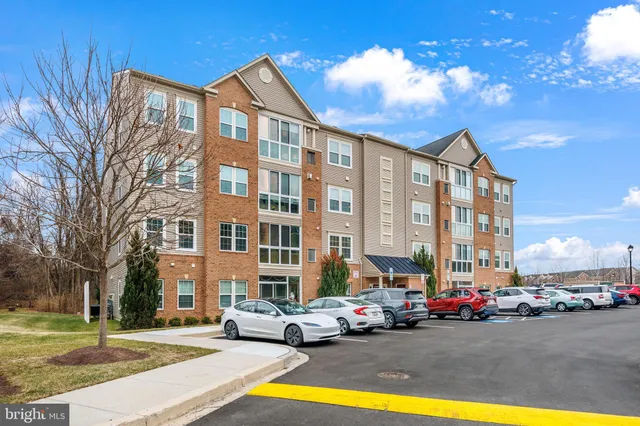 a view of a building with cars parked in front of it