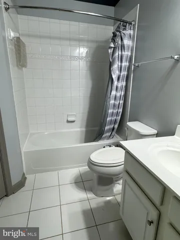 a white toilet sitting next to a bath tub and shower