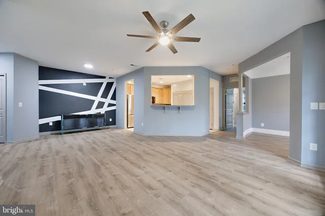 a view of a livingroom with a ceiling fan and window