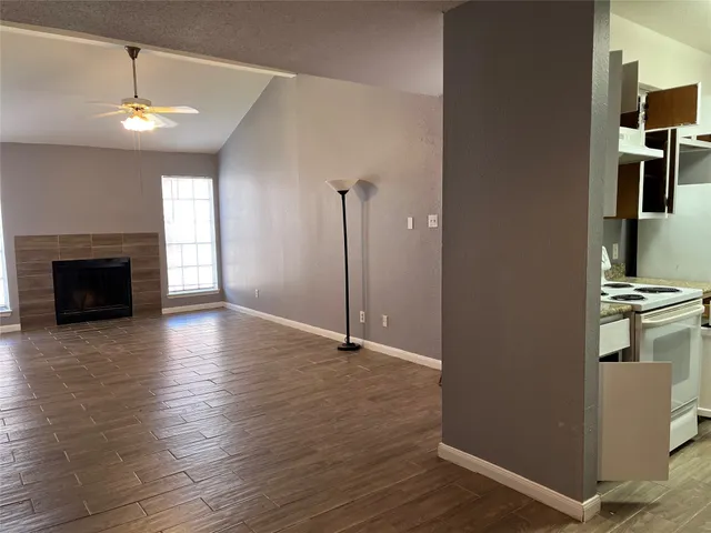 a view of a kitchen with a sink and a refrigerator