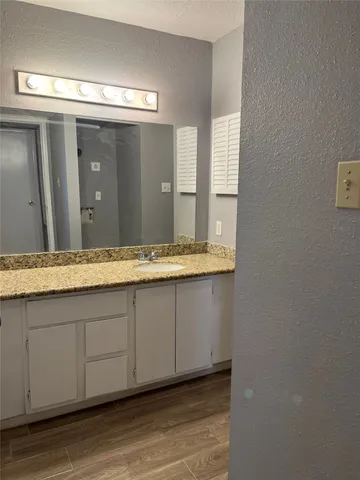 a bathroom with a double vanity sink and mirror