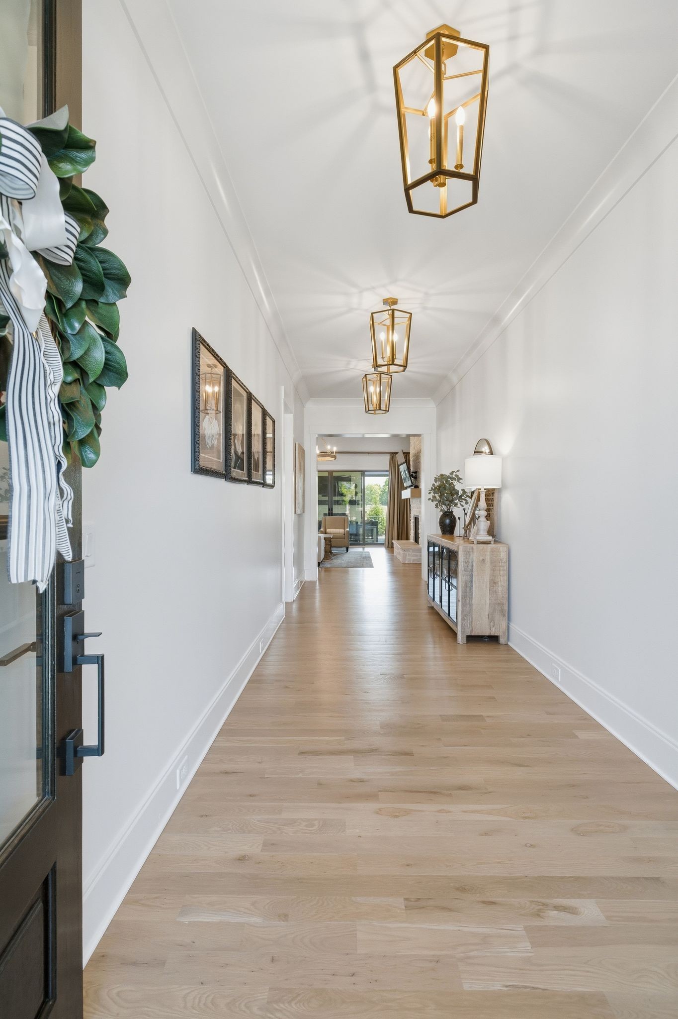 1733 Rigsby Avenue Murfreesboro, TN 37129 - Photo 6 of 57 a view of a hallway with wooden floor and a potted plant