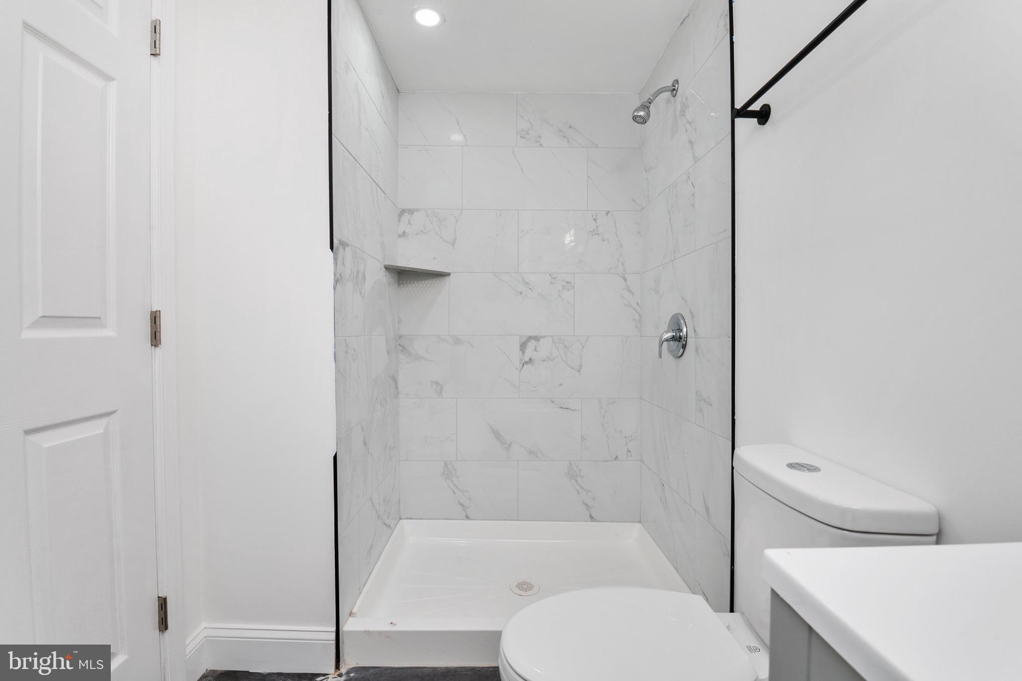 2828 Lake Avenue Baltimore, MD 21213 - Photo 22 of 28 a bathroom with a shower a toilet and a shower