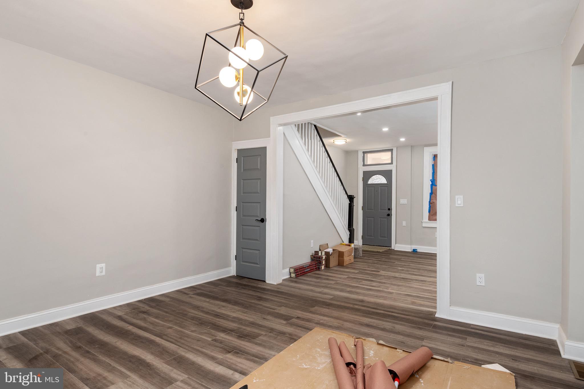 2828 Lake Avenue Baltimore, MD 21213 - Photo 6 of 28 a view of a livingroom with wooden floor and stairs