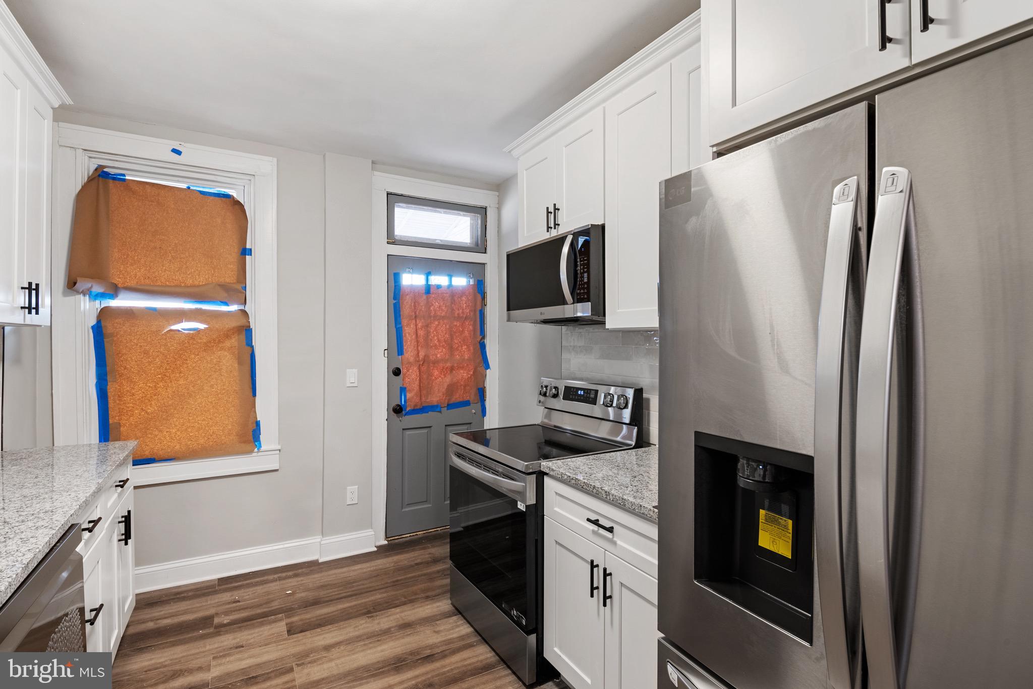 2828 Lake Avenue Baltimore, MD 21213 - Photo 10 of 28 a kitchen with stainless steel appliances a refrigerator stove and microwave