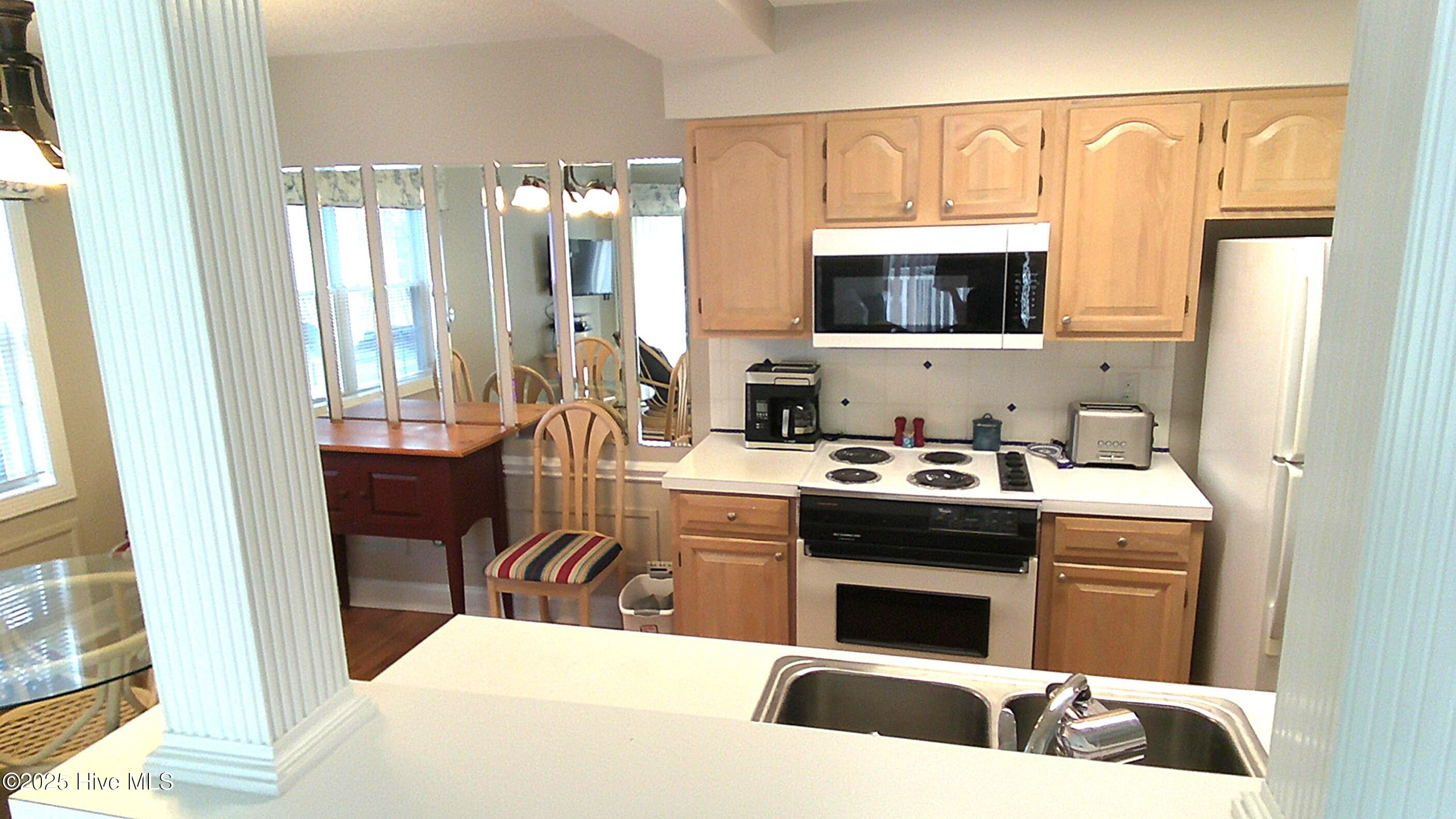908 Resort Circle, Unit 108 Sunset Beach, NC 28468 - Photo 21 of 36 kitchen from breakfast bar